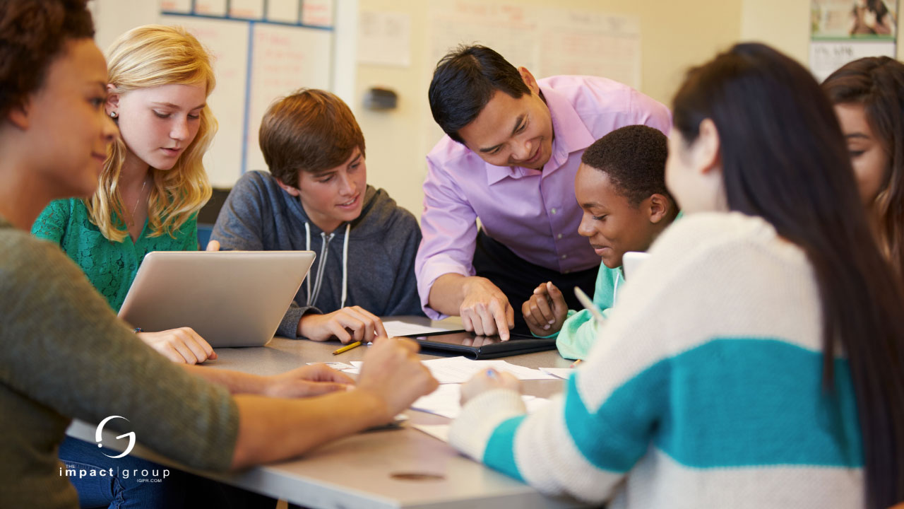 A group of diverse students engaged in collaborative learning with a mentor, highlighting leadership and communication strategies.